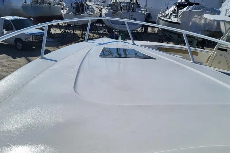  Yacht Photos Pics 2007 Intrepid 370 Cuddy boat deck with railing, surrounded by other boats.