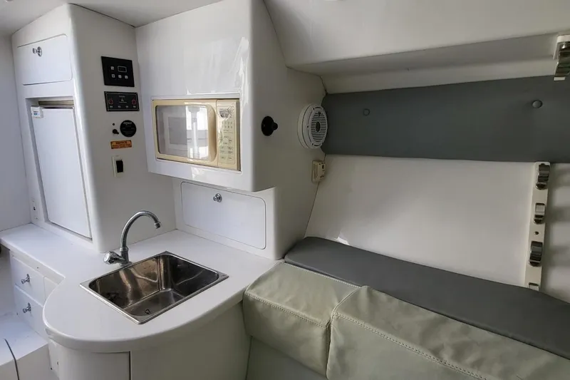  Yacht Photos Pics 2007 Intrepid 370 Cuddy interior with kitchenette, sink, microwave, and seating area.