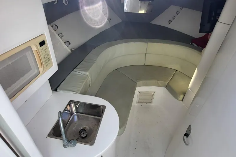  Yacht Photos Pics 2007 Intrepid 370 Cuddy interior with kitchenette, sink, and curved seating area.