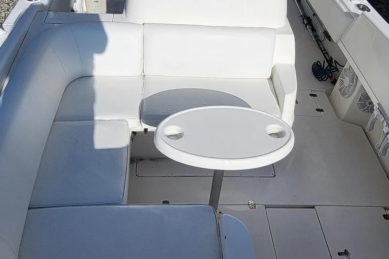  Yacht Photos Pics 2007 Intrepid 370 Cuddy boat interior with white seating and round table.