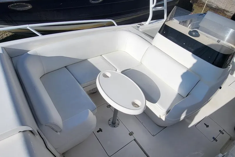  Yacht Photos Pics 2007 Intrepid 370 Cuddy boat interior with white seating and round table.