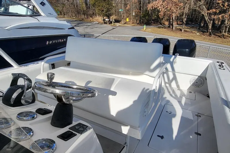  Yacht Photos Pics 2007 Intrepid 370 Cuddy boat interior with steering wheel and seating area.