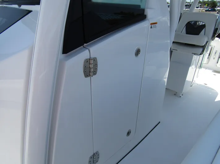  Yacht Photos Pics 2024 Wellcraft 352 Fisherman boat, close-up of cabin door and seating area.