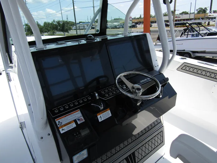  Yacht Photos Pics 2024 Wellcraft 352 Fisherman boat dashboard with dual screens and steering wheel.