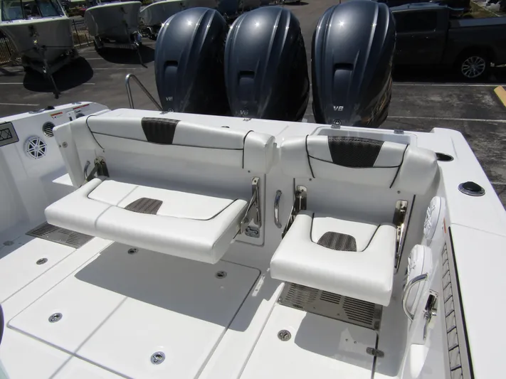  Yacht Photos Pics 2024 Wellcraft 352 Fisherman boat with triple outboard engines and foldable seating.