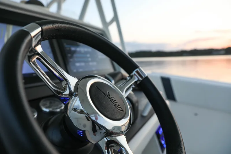  Yacht Photos Pics Steering wheel of a 2008 Midnight Express 37 boat at sunset on the water.