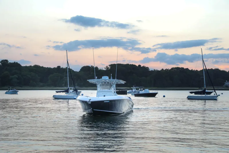  Yacht Photos Pics Midnight Express 37 boat on serene water at sunset, 2008 model.
