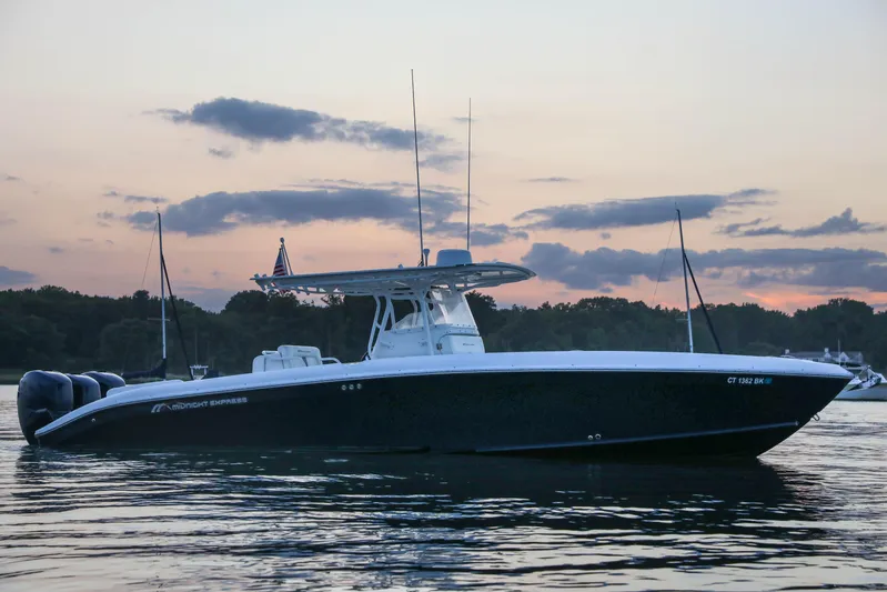  Yacht Photos Pics 2008 Midnight Express 37 boat on calm water at sunset.