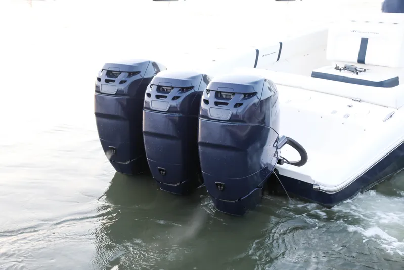  Yacht Photos Pics 2008 Midnight Express 37 boat with triple outboard engines in water.