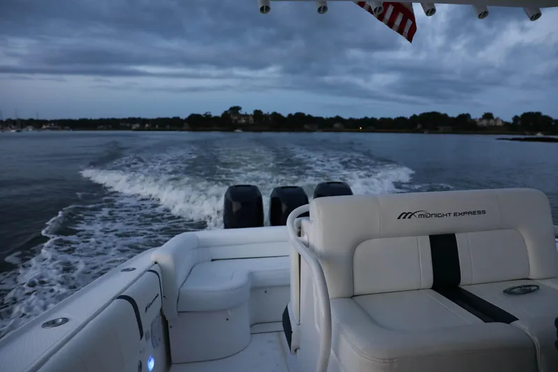  Yacht Photos Pics Midnight Express 37 boat cruising on water at dusk, 2008 model.