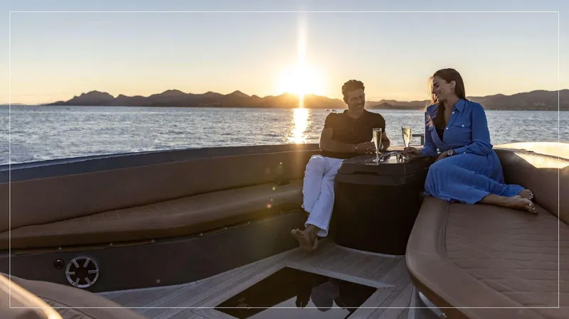 Stanislas Michel Yacht Photos Pics Couple enjoying sunset on 2016 SACS Strider 18 yacht, with drinks and ocean view.