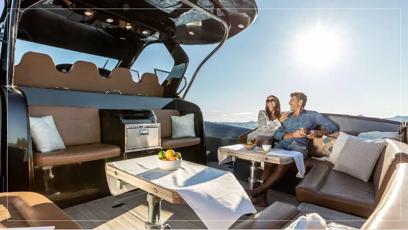 Stanislas Michel Yacht Photos Pics Couple relaxing on 2016 SACS Strider 18 yacht with luxurious seating and ocean view.