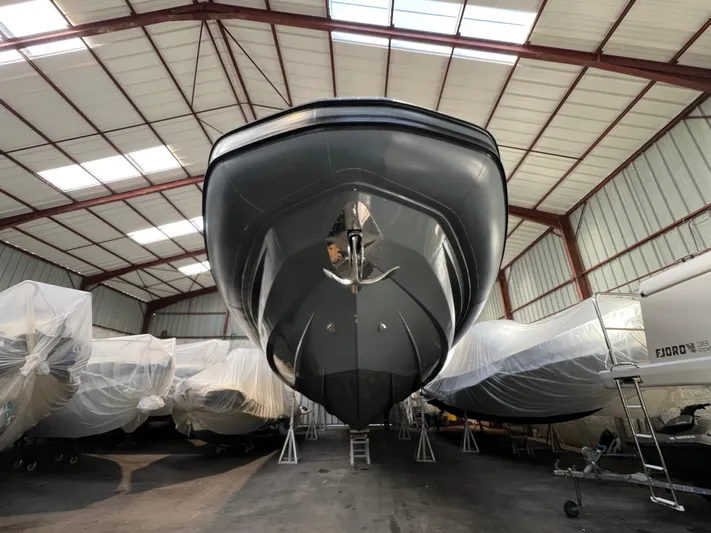 Stanislas Michel Yacht Photos Pics 2016 SACS Strider 18 boat in storage, viewed from below in a warehouse.