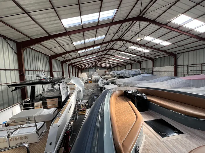 Stanislas Michel Yacht Photos Pics Indoor storage of 2016 SACS Strider 18 boats in a large warehouse.