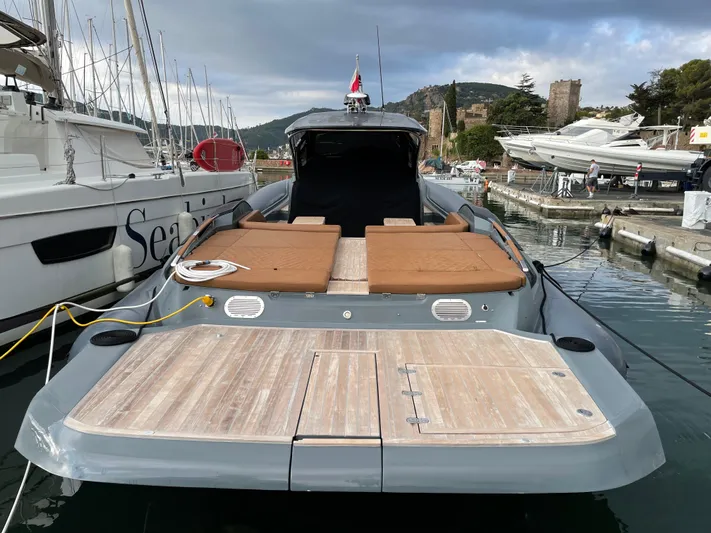 Stanislas Michel Yacht Photos Pics Luxury SACS Strider 18 yacht docked, featuring spacious deck and sunbeds, 2016 model.