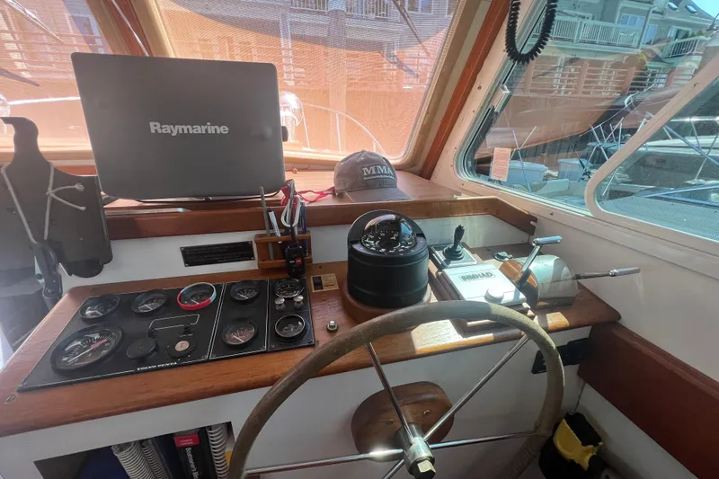 Oasis Yacht Photos Pics 1987 Wilbur 38 boat helm with Raymarine equipment and navigation controls.