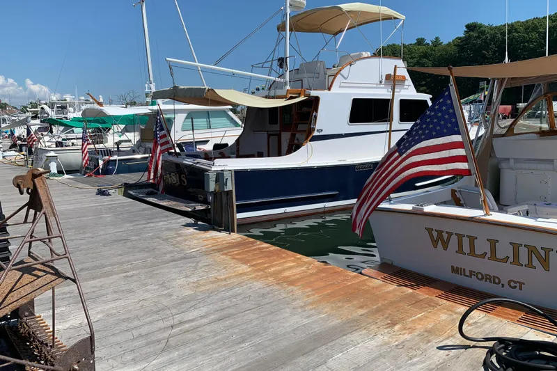 Oasis Yacht Photos Pics Boats docked at marina, featuring 1987 Wilbur 38, with American flags waving.