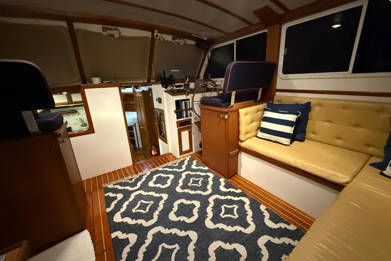 Oasis Yacht Photos Pics Interior of 1987 Wilbur 38 boat with cozy seating and nautical decor.