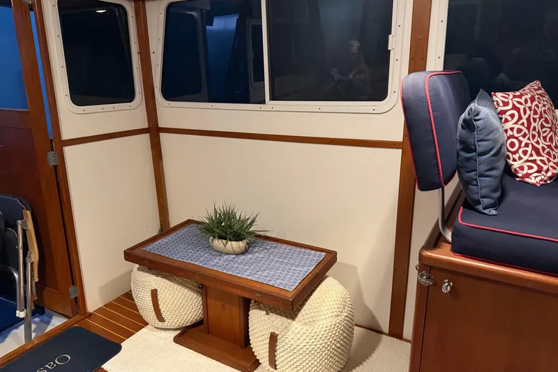 Oasis Yacht Photos Pics Interior of 1987 Wilbur 38 boat with cozy seating and decorative pillows.