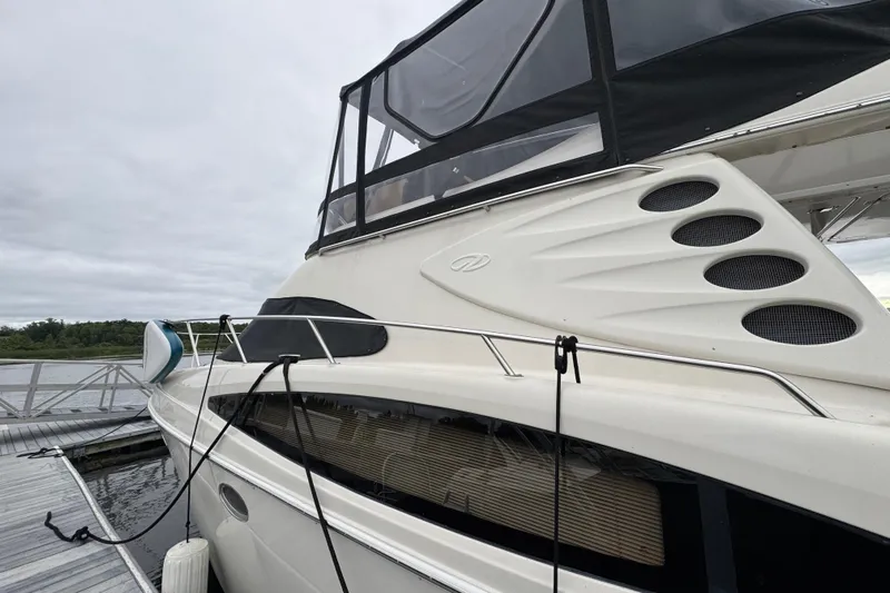 25 Knots Yacht Photos Pics 2001 Regal Commodore 3780 yacht docked, featuring sleek design and modern amenities.