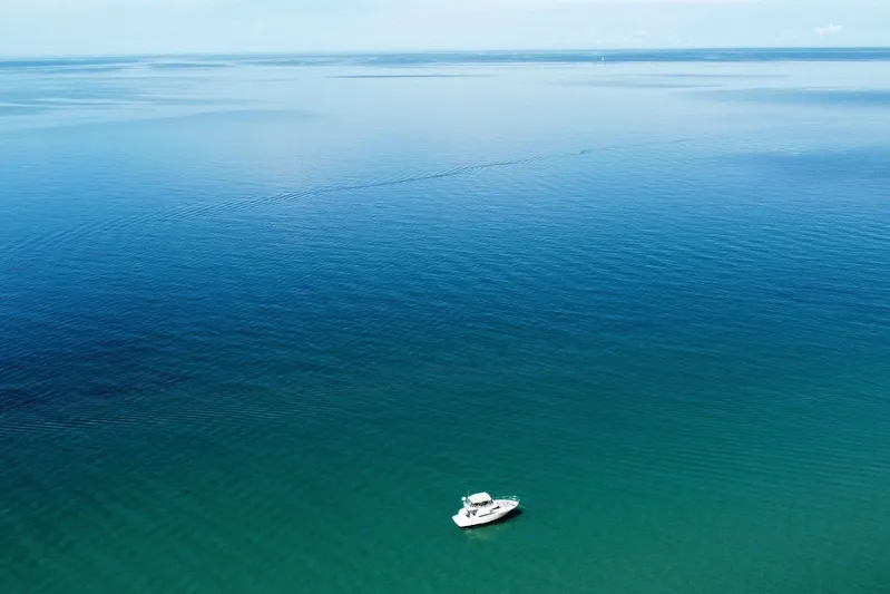 25 Knots Yacht Photos Pics Aerial view of 2001 Regal Commodore 3780 yacht on calm blue ocean.