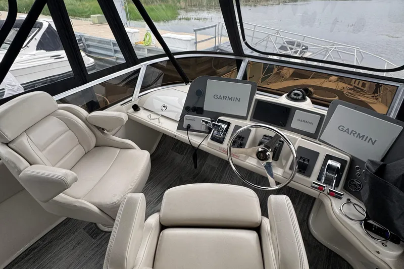 25 Knots Yacht Photos Pics Cockpit of 2001 Regal Commodore 3780 with Garmin navigation displays and plush seating.