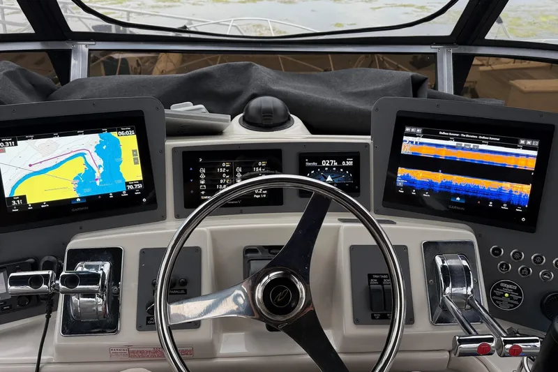 25 Knots Yacht Photos Pics Cockpit of 2001 Regal Commodore 3780 with navigation displays and steering wheel.