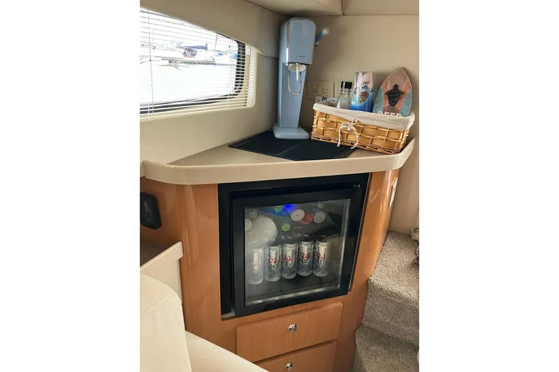 25 Knots Yacht Photos Pics Mini bar area in 2001 Regal Commodore 3780 yacht with beverage fridge and coffee maker.
