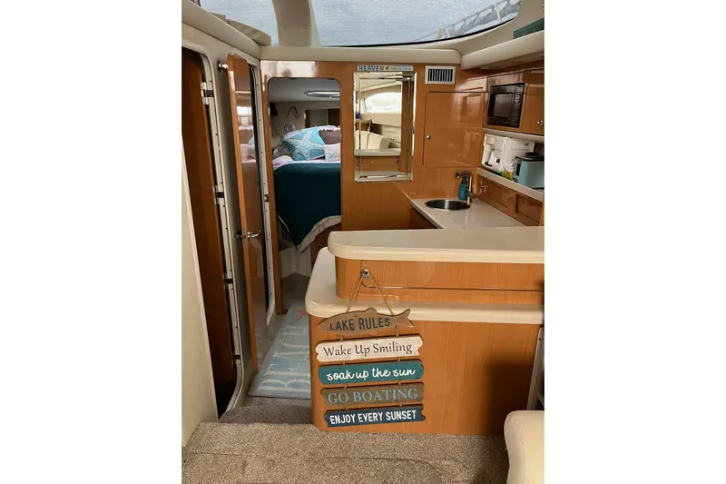 25 Knots Yacht Photos Pics Interior of 2001 Regal Commodore 3780 yacht with cozy cabin and kitchen area.