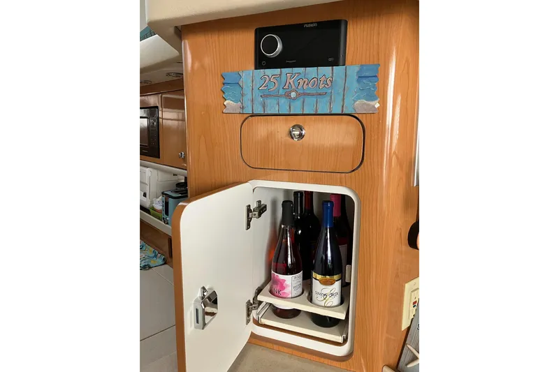 25 Knots Yacht Photos Pics Wine storage cabinet on 2001 Regal Commodore 3780 yacht interior.