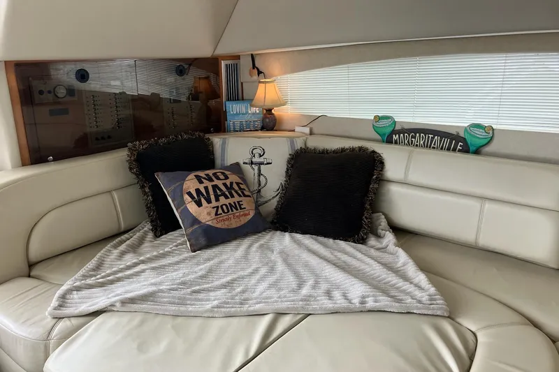25 Knots Yacht Photos Pics Cozy interior of 2001 Regal Commodore 3780 yacht with decorative pillows and blanket.