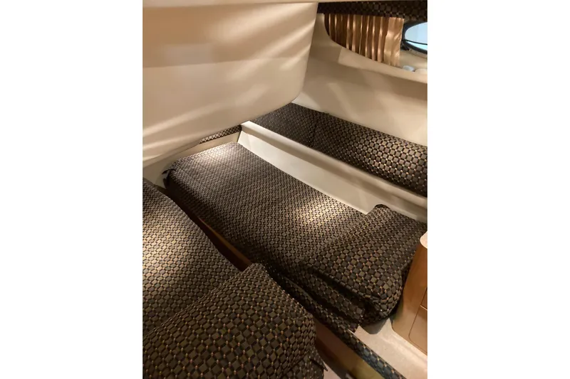 25 Knots Yacht Photos Pics 2001 Regal Commodore 3780 interior with patterned seating and cozy cabin design.