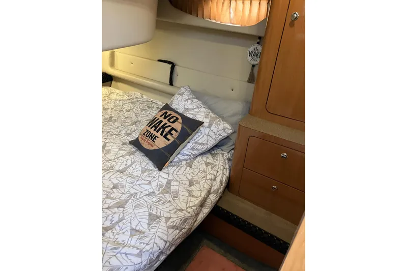 25 Knots Yacht Photos Pics Cozy cabin interior of 2001 Regal Commodore 3780 with "No Wake Zone" pillow.