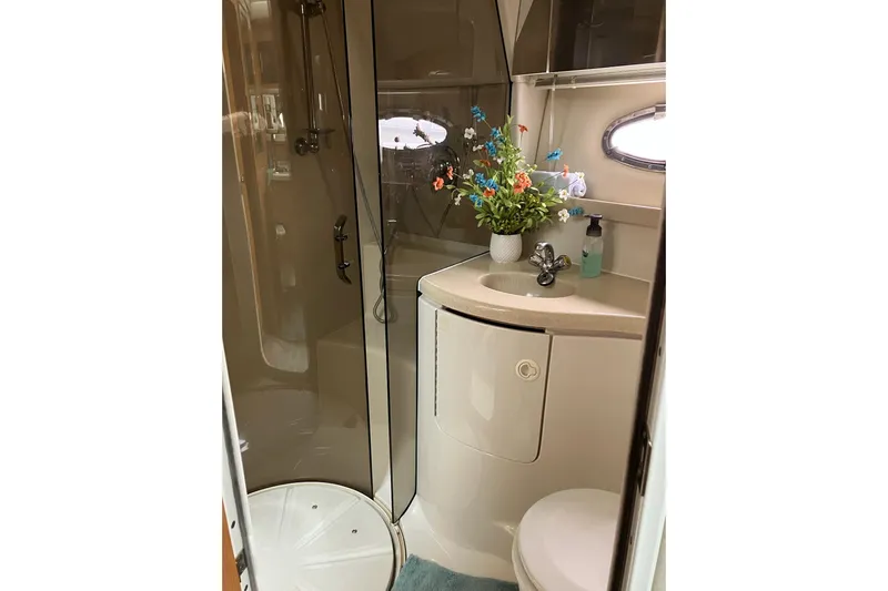 25 Knots Yacht Photos Pics Luxurious bathroom in 2001 Regal Commodore 3780 yacht with shower and floral decor.