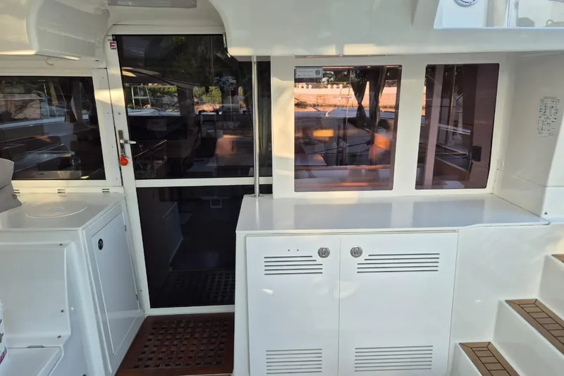 Chapter Two Yacht Photos Pics 2014 Lagoon 450 yacht interior with sleek white cabinetry and large windows.