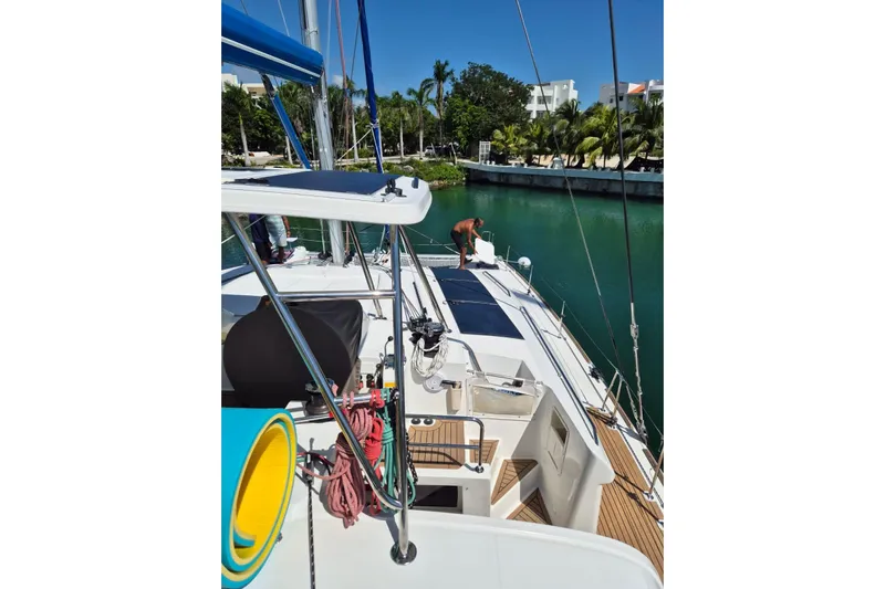 Chapter Two Yacht Photos Pics 2014 Lagoon 450 yacht docked in a tropical marina with lush greenery.