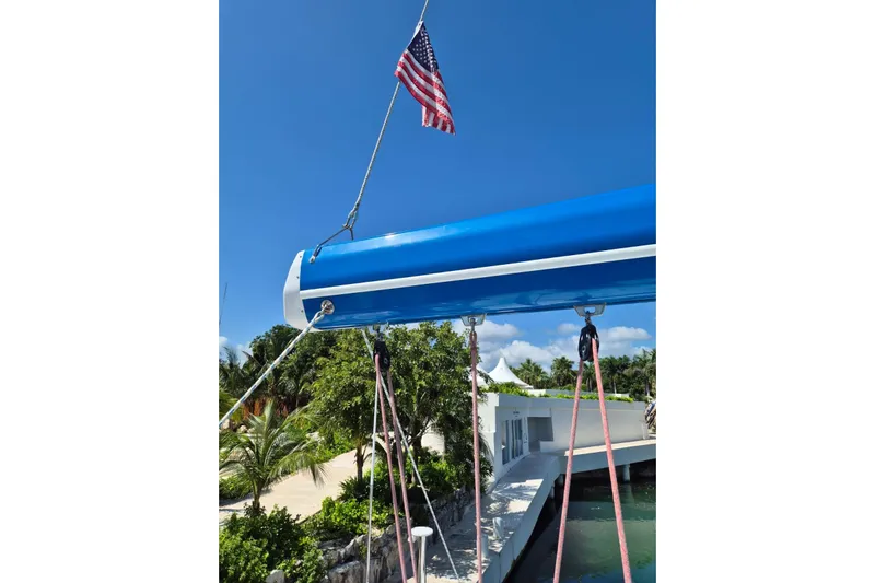 Chapter Two Yacht Photos Pics American flag on Lagoon 450 catamaran, 2014 model, with tropical backdrop.