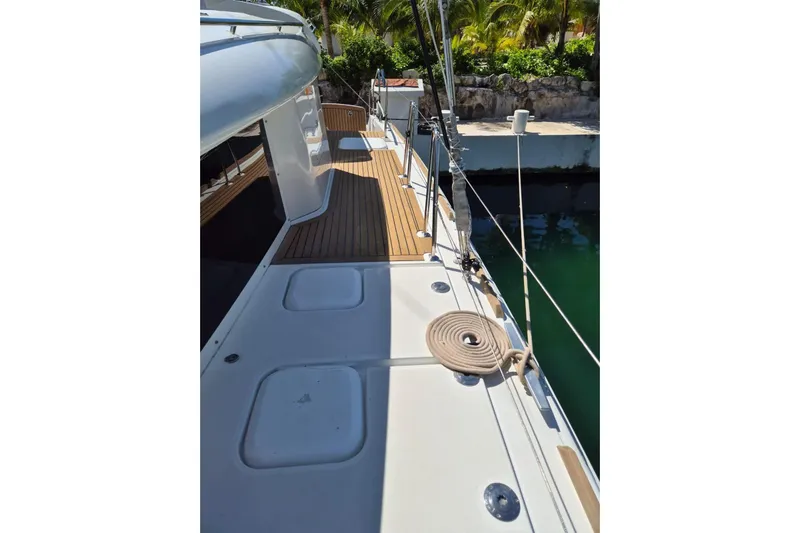 Chapter Two Yacht Photos Pics Deck view of a 2014 Lagoon 450 catamaran, featuring teak flooring and coiled rope.