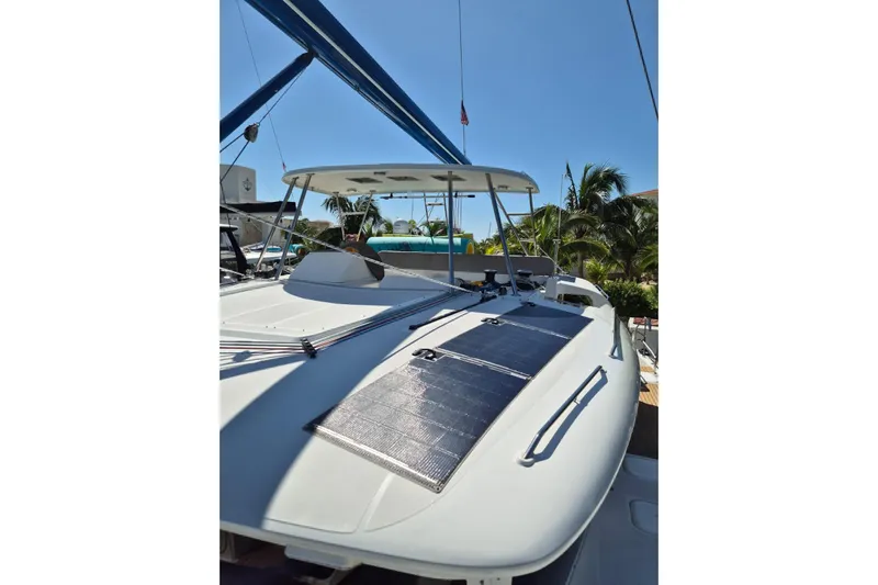 Chapter Two Yacht Photos Pics 2014 Lagoon 450 catamaran with solar panels, docked under clear blue sky.