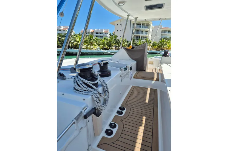 Chapter Two Yacht Photos Pics Lagoon 450 catamaran deck, 2014 model, featuring winches and ropes, docked near tropical resort.