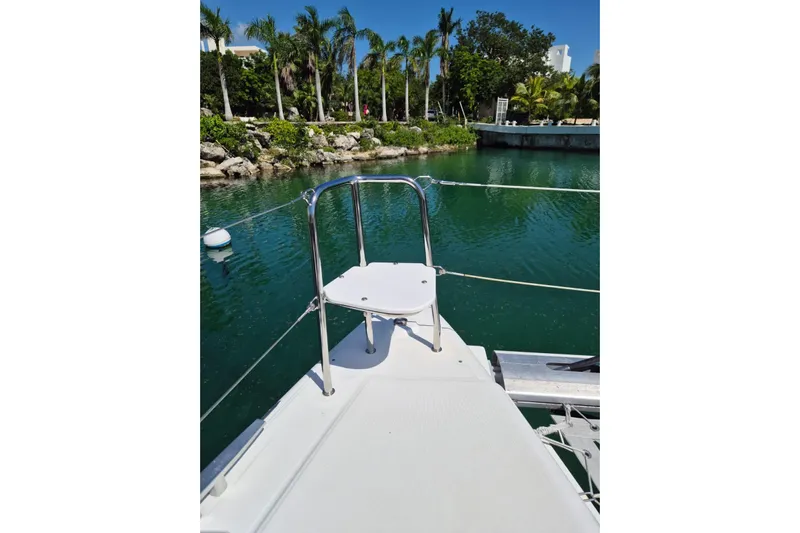 Chapter Two Yacht Photos Pics Front deck of 2014 Lagoon 450 catamaran docked by lush greenery.