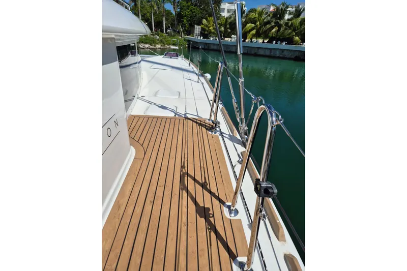 Chapter Two Yacht Photos Pics Deck view of 2014 Lagoon 450 catamaran with teak flooring and stainless steel railings.