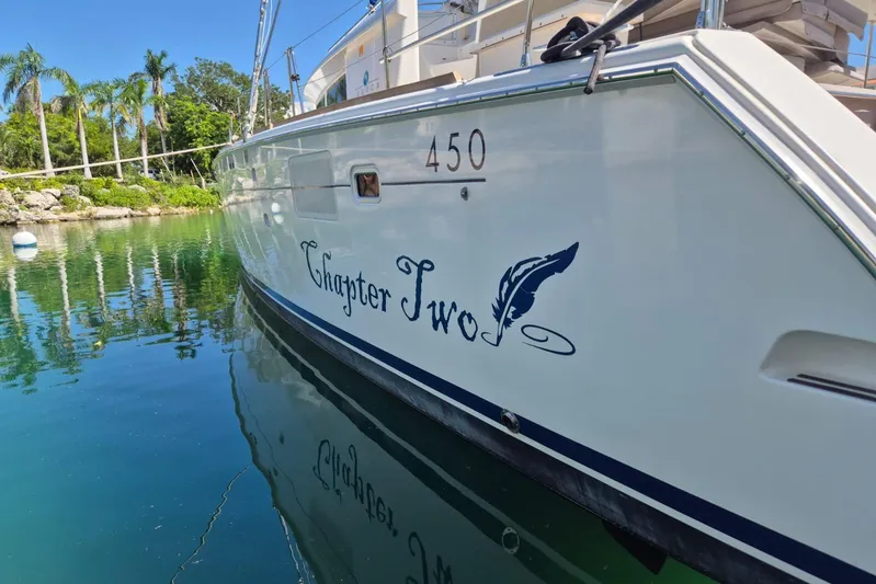 Chapter Two Yacht Photos Pics 2014 Lagoon 450 catamaran named "Chapter Two" docked in a serene marina.