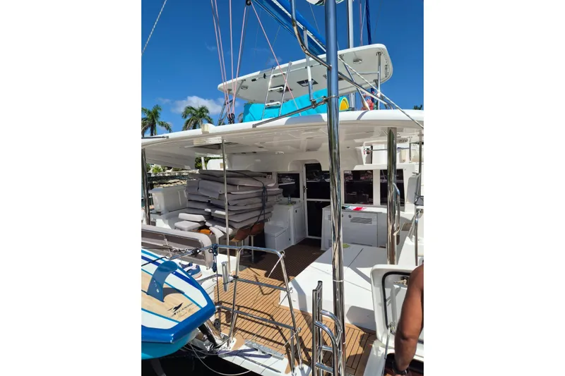 Chapter Two Yacht Photos Pics 2014 Lagoon 450 catamaran with stacked cushions, docked under clear blue sky.