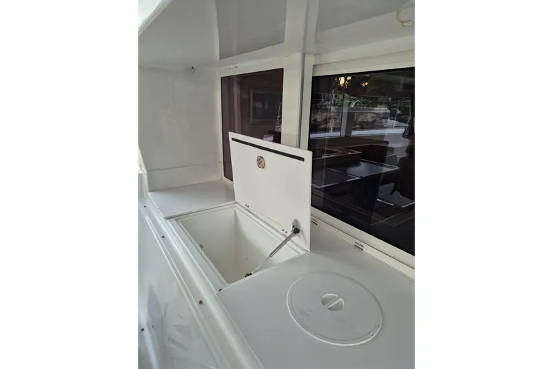 Chapter Two Yacht Photos Pics 2014 Lagoon 450 yacht interior with open storage compartment and window view.