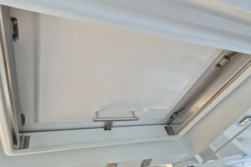Chapter Two Yacht Photos Pics Ceiling hatch of a 2014 Lagoon 450 catamaran, featuring stainless steel hardware.