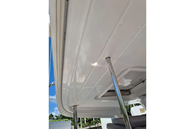Chapter Two Yacht Photos Pics 2014 Lagoon 450 yacht canopy with stainless steel support, clear sky background.
