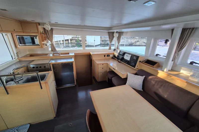 Chapter Two Yacht Photos Pics Luxurious interior of 2014 Lagoon 450 catamaran with modern kitchen and spacious seating area.