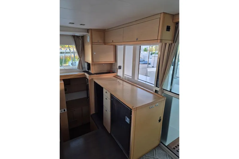 Chapter Two Yacht Photos Pics Interior of 2014 Lagoon 450 yacht with wooden cabinetry and large windows.