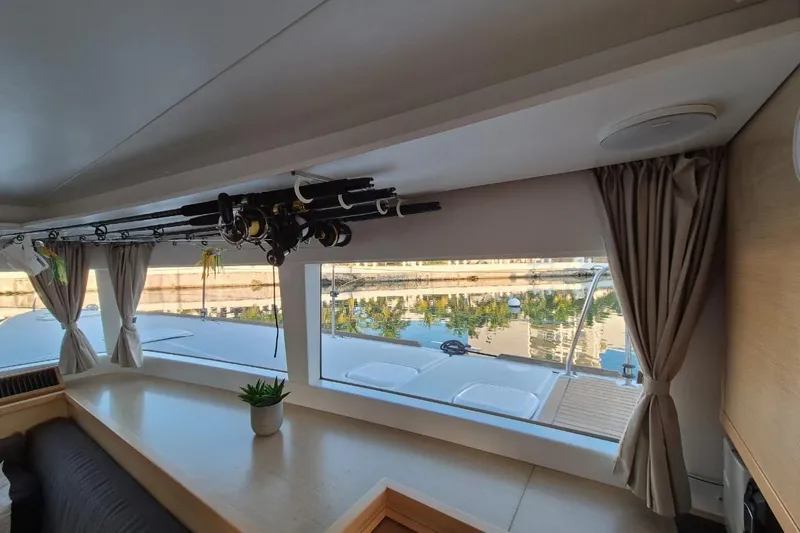 Chapter Two Yacht Photos Pics Interior of 2014 Lagoon 450 catamaran with fishing rods and scenic window view.